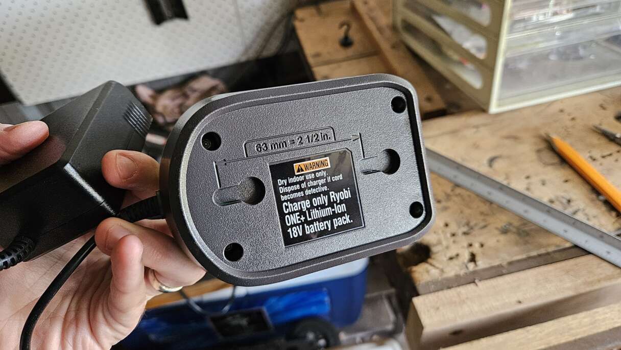 The underside of a Ryobi battery charger with convenient mounting holes